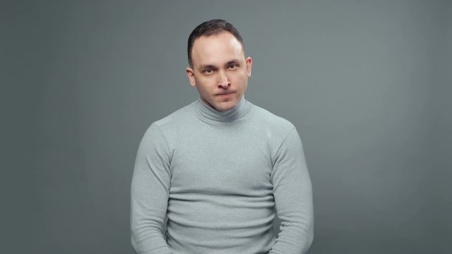 Shooting of young grumpy man in turtleneck