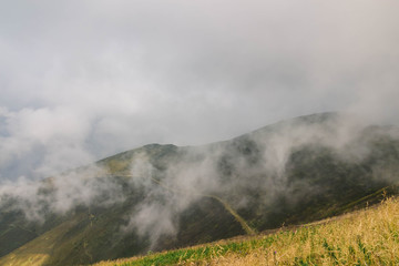 Beautiful Carpathians, mountains in clouds, waterfall, close-up, the sunsets beautifully over the mountains