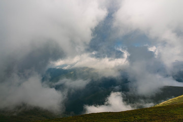 Beautiful Carpathians, mountains in clouds, waterfall, close-up, the sunsets beautifully over the mountains