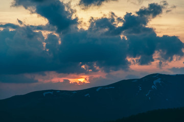 Beautiful Carpathians, mountains in clouds, waterfall, close-up, the sunsets beautifully over the mountains