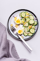 Easy vegetarian salad with cucumber, onion and eggs with vinaigrette sauce. Healthy nutrition. Selective focus