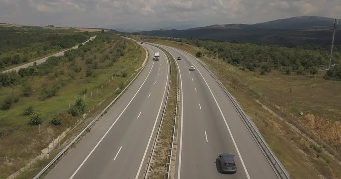 An aerial view of the busy M1 Motorway in Greece with speeding traffic including cars and lorries with copy space.