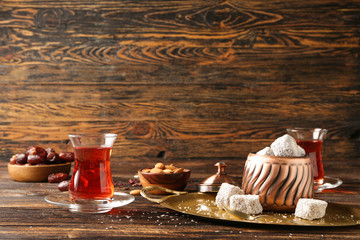 Tasty Turkish tea with sweets on table