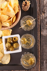 chips, alcohol and olive- top view