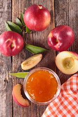 peach jam on wood background- top view