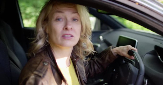4K Woman with bad attitude being questioned by a traffic cop standing at car window. Slow motion.