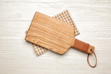 Cutting board on white wooden background