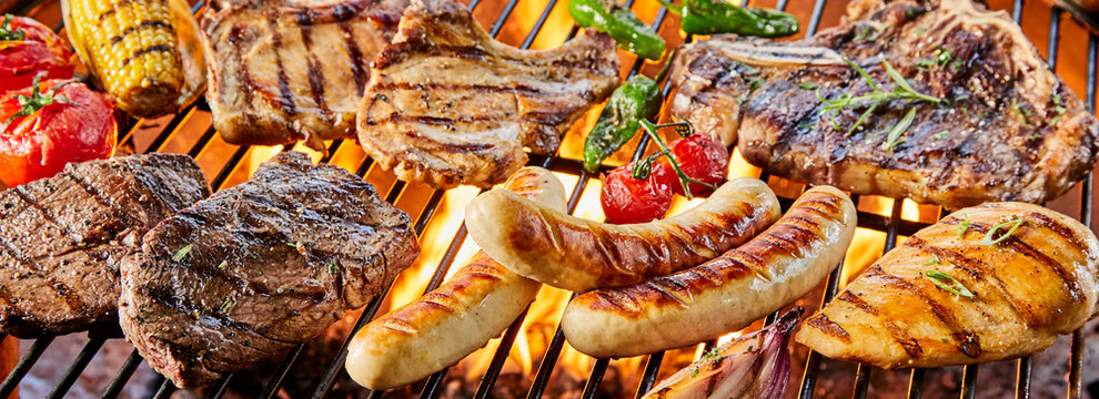 Large assortment of meat grilling on a barbecue