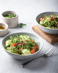 Healthy vegetarian salad bowl - vegetables, micro greens, avocado, sesame .