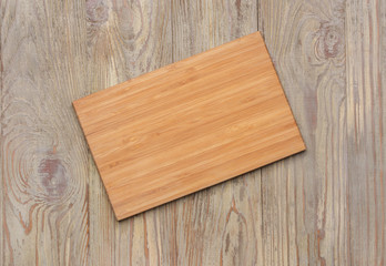 Naklejka na ściany i meble Cutting board on wooden background