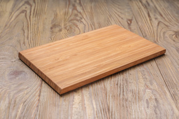 Cutting board on wooden background