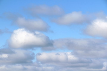 Naklejka na ściany i meble Lovely white fluffy clouds on a background of blue sky.