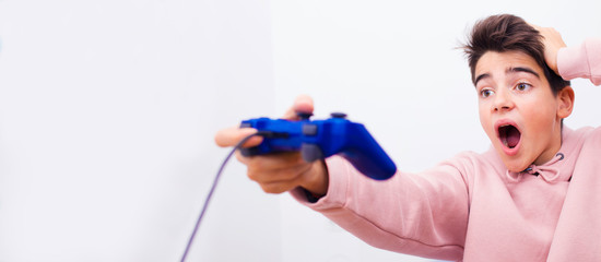 boy with game console joystick and surprise expression isolated on background with space