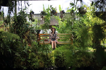 Woman sitting in a green garden