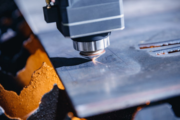 Laser CNC cut of metal with light spark, technology modern industrial. Blue color steel