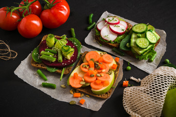 Set Vegetarian sandwiches, vegetables and fruits burger, healthy Breakfast on black concrete background,Vegan food.