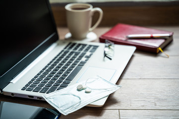 The concept of remote work at home during the coronavirus epidemic. Workplace with laptop, smartphone and notepad