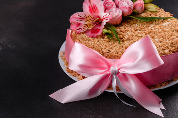 Fresh delicious cake napoleon with cream on a dark background