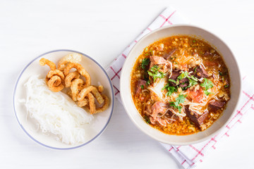Local Northern Thai food (Kanom Jeen Nam Ngeaw), rice noodles with spicy soup eating with pork rind, Top view