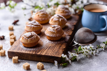 Fresh baked cupcakes of rice flour with banana and vanilla with a mug of hot chocolate