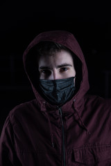 Criminal in a jacket and a black mask during quarantine