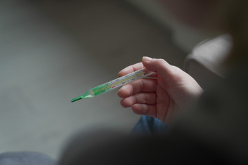 female hand are holding a thermometer