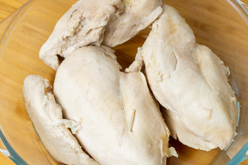 boiled chicken breast in a plate on the table close up