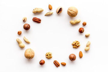 Nuts background - healthy snacks concept - on white table top-down frame copy space