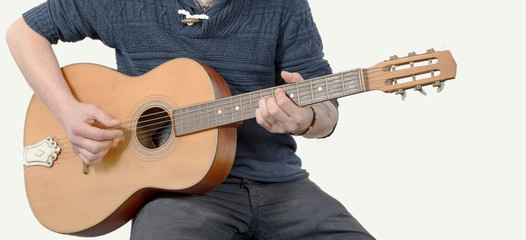 close up of hands man with an acoustic guitar