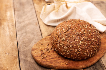 Freshly baked traditional bread on wooden table