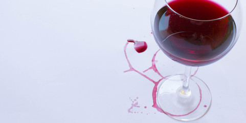  A glass of pink red wine on white background with Traces of wine. Free copy space.  Concept of organic drinks. banner