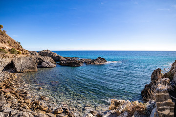 Fototapeta na wymiar A beautiful beach accesible by a tunnel in a rock, (telegraph tip) Punta del Telegrafo on the Tyrrhenian coast of Ascea Marina. Cilento, Salerno, Campania, Italy