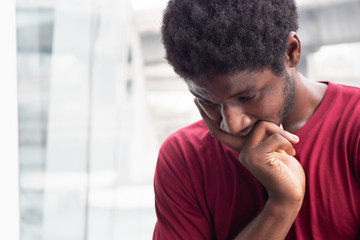 stressed African black man thinking, planning; portrait of serious Afro man thinking with stress for concept of idea finding, future job plan, recession or money problem in urban environment