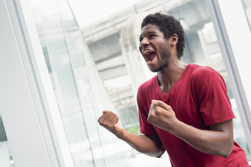 Angry man shouting with anger; portrait of African black man shouting, screaming with angry emotion...