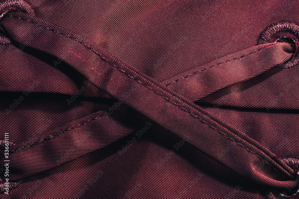 Poster Close up beautiful red textile cloth background with stitching. Macro photography background material view.