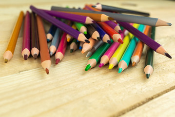 Obraz premium colored pencils on a wooden background,close-up