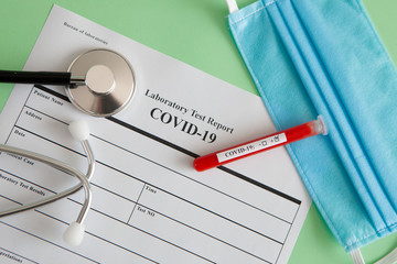 World coronavirus epidemic concept. Pandemic COVID-19, 2019-nKoV. Coronavirus vaccine testing. Positive analysis and laboratory blood sample. Test tube, vaccine, mask.