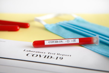 World coronavirus epidemic concept. Pandemic COVID-19, 2019-nKoV. Coronavirus vaccine testing. Positive analysis and laboratory blood sample. Test tube, vaccine, mask.
