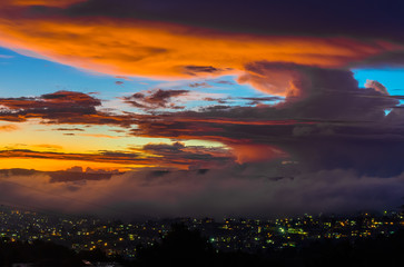 Beautiful sunset over the city near the lake