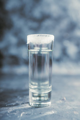Tequila shots on the dark rustic background. Selective focus. Shallow depth of field.