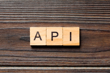 API word written on wood block. API text on wooden table for your desing, Top view concept