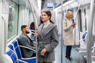 Fototapeta na wymiar Young brunette traveling by subway car