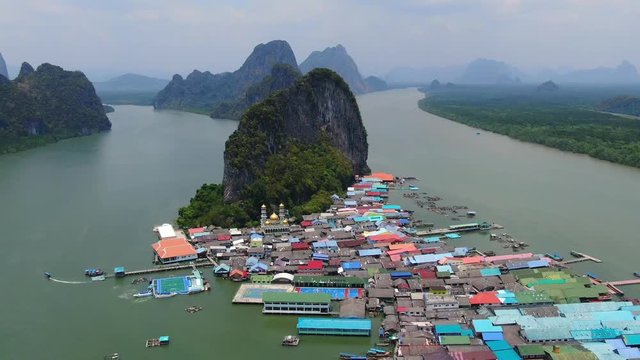 Drone backwards shot of Aerial view over Ko Panyi floating village in south of Thailand. Ko Panyi is a fishing and muslim village in Phang Nga Province.