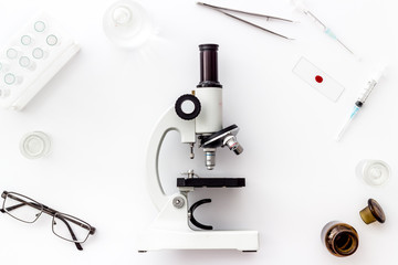 Laboratory examination with microscope. Equipment on white background top view