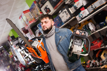 Active male is buying new chainsaw