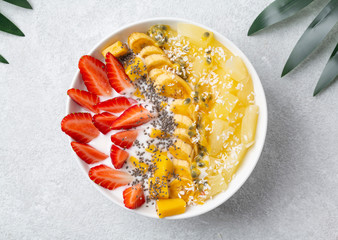 Healthy Breakfast smoothie bowl with yogurt, tropical fruits and Chia seeds.