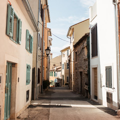 Fototapeta na wymiar Travel summer concept. Old city view of Europe, Croatia, Istria region, Rovinj. Empty street with old buildings with shutters.