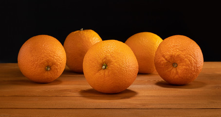 group of oranges on old rustic wood table