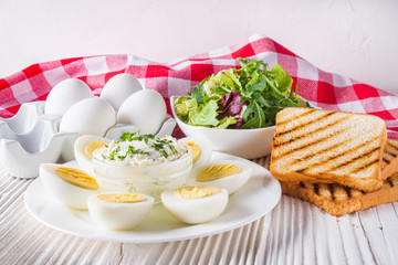 boiled chicken eggs on a white wooden rustic background