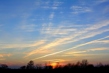 Sunset over the forest in the village